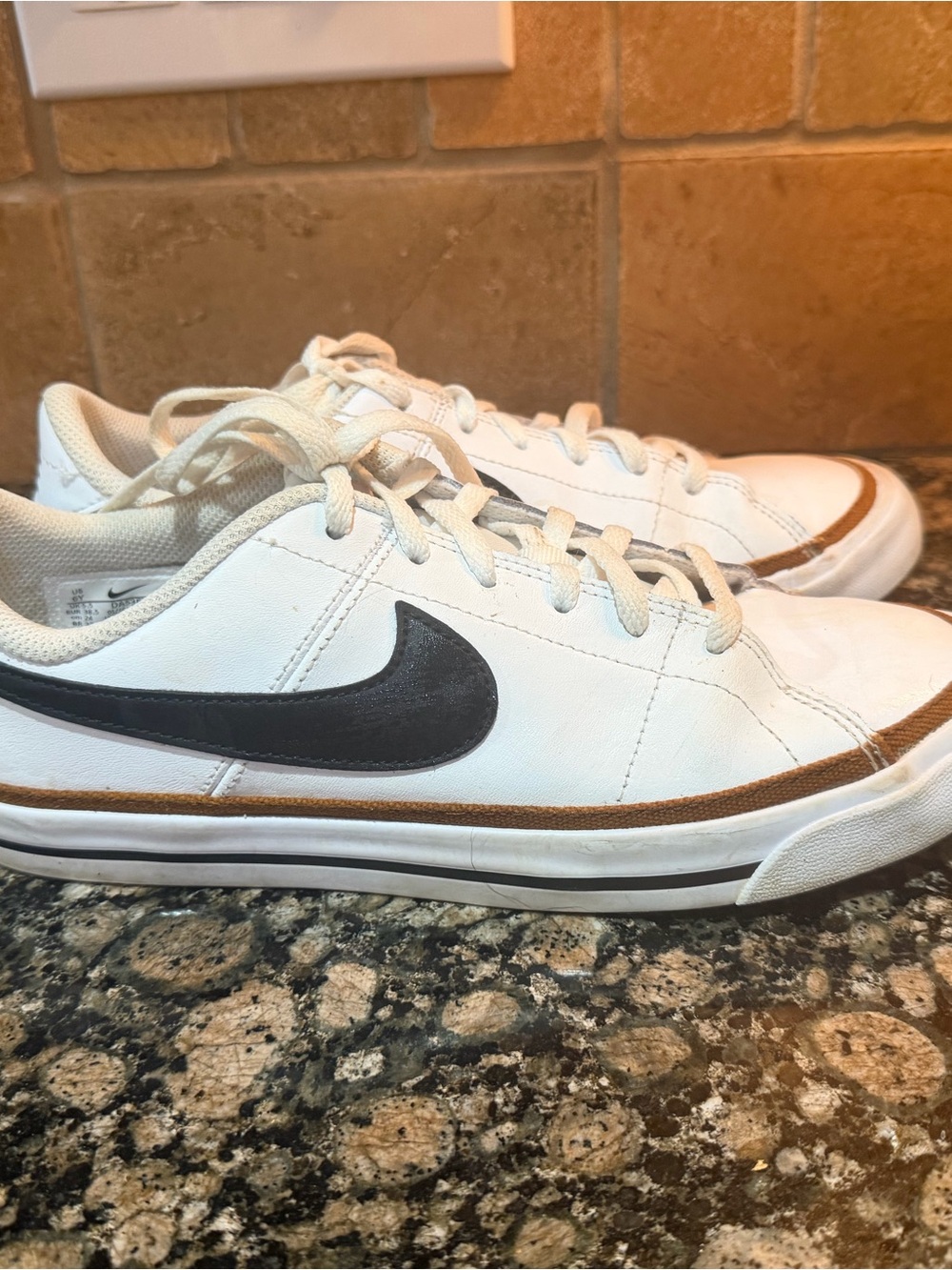 Nike White Low-Top Sneakers with Black Swoosh and Brown Trim